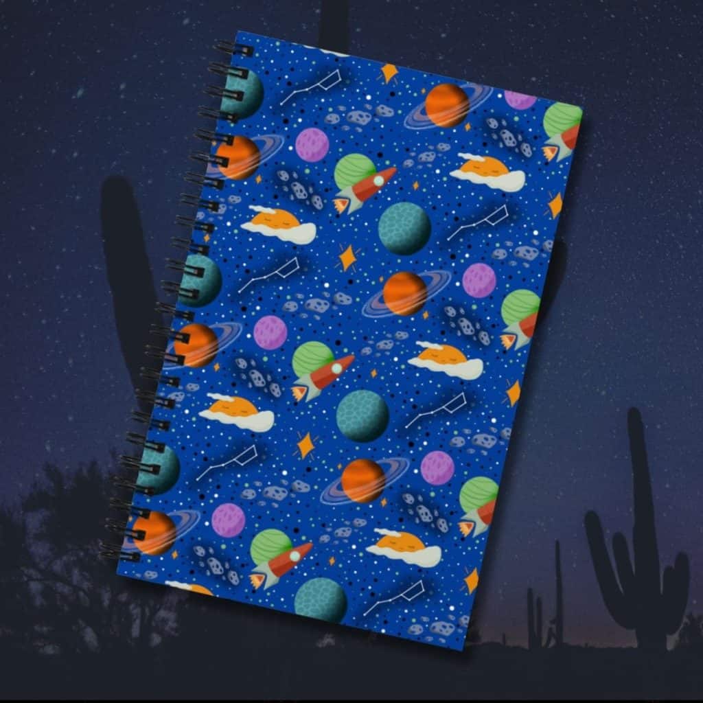 Sleepy space adventure celestial spiral notebook, hand-drawn planets and stars illustration by Tucson illustrator Nicole Peery