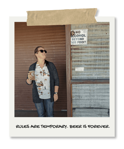 Enjoying a cold beer at a relaxed outdoor spot with a "No Alcohol Beyond This Point" sign.