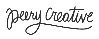 Creative woman working on digital art at a desk with colorful supplies.