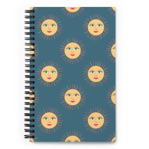 Celestial spiral notebook with hand-drawn golden sun faces on desert blue hardcover with dotted pages